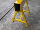 Yellow metal trestle on a concrete floor.