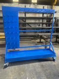 Blue mobile industrial cart with multiplehook on a warehouse floor.