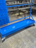 Blue metal rolling equipment storage cart on castors.